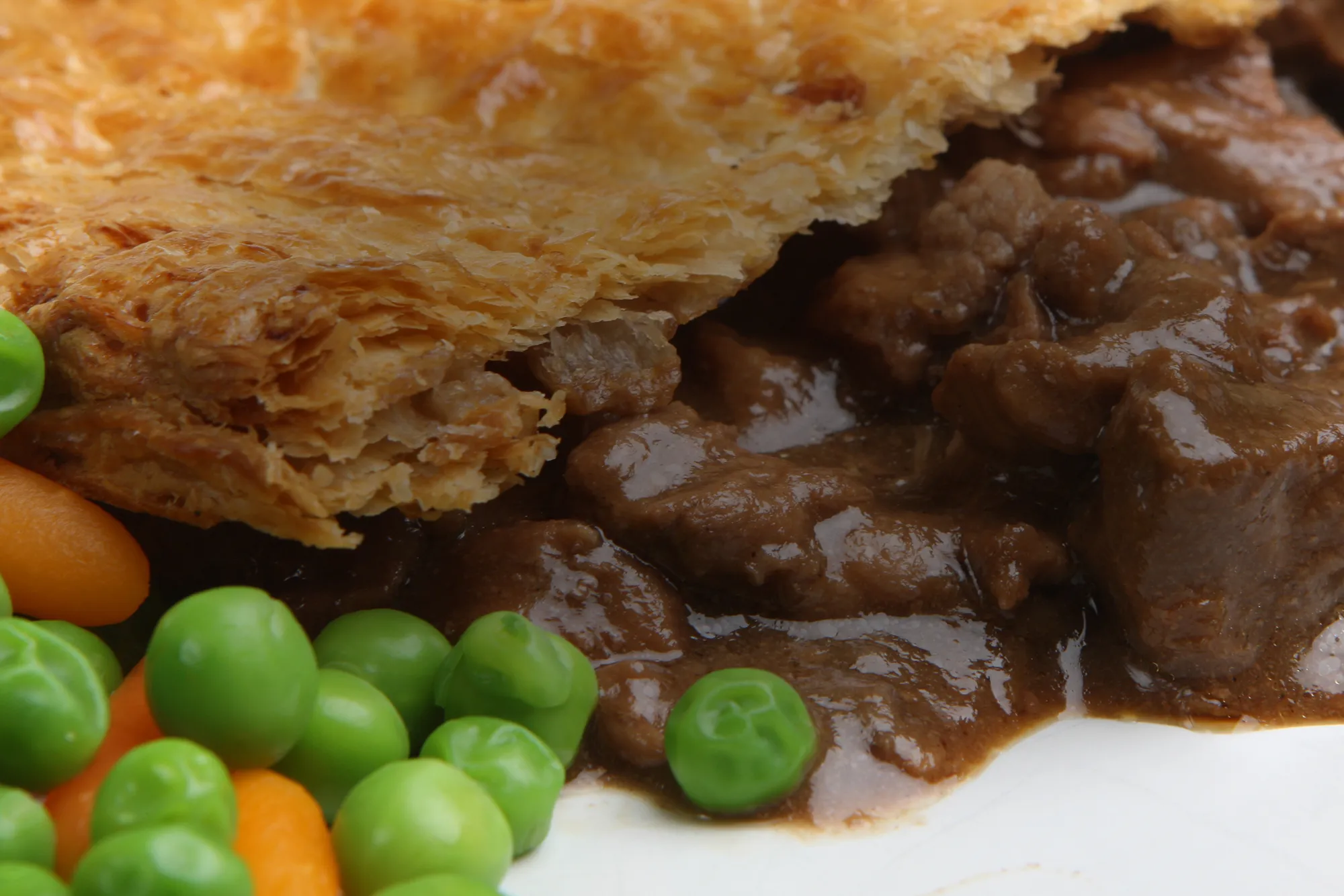 Steak pie with peas and carrots